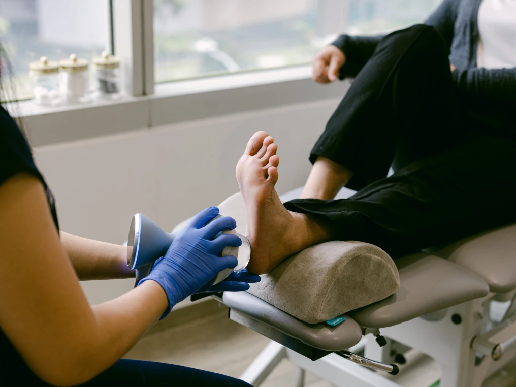 podiatrist providing heel pain treatment using shockwave therapy