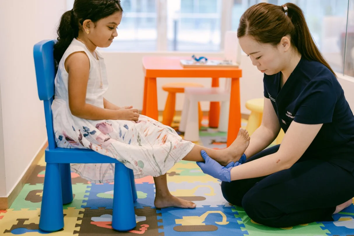 Podiatrist assessing child foot at Staits Podiatry Singapore