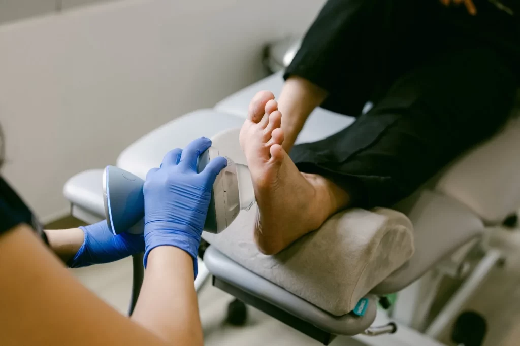 podiatrist treating arch pain with shockwave therapy.