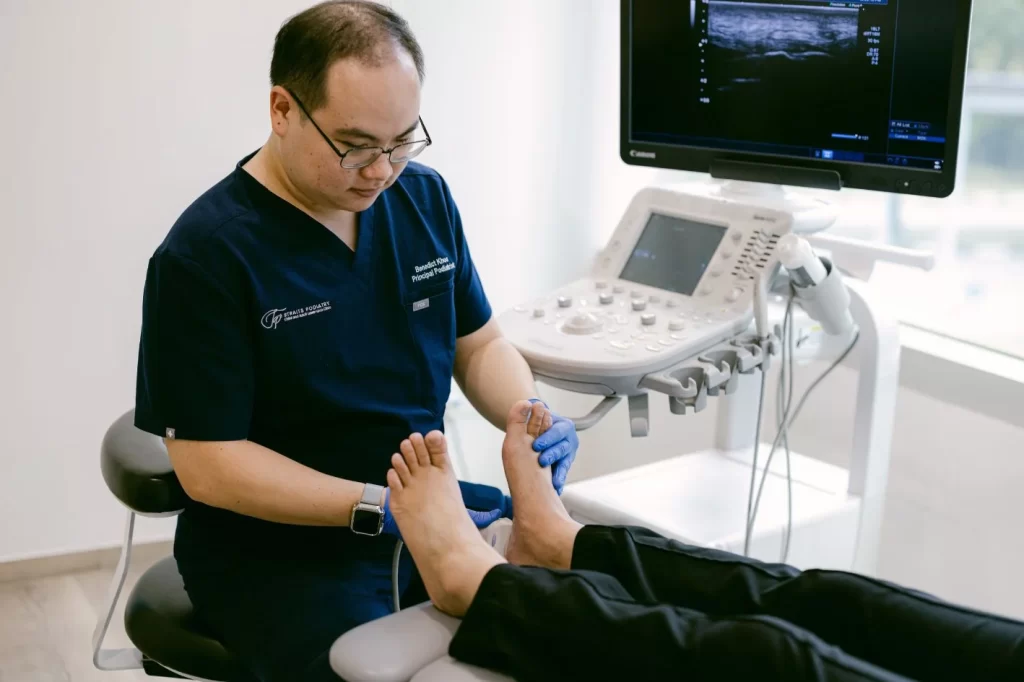 podiatrist in Singapore performing diagnostic ultrasound to assess foot pain