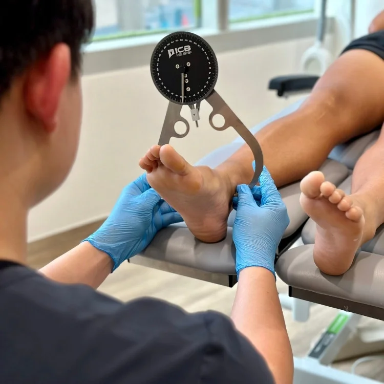 podiatrist Jackie Tey assess patient's foot pain using a goniometer