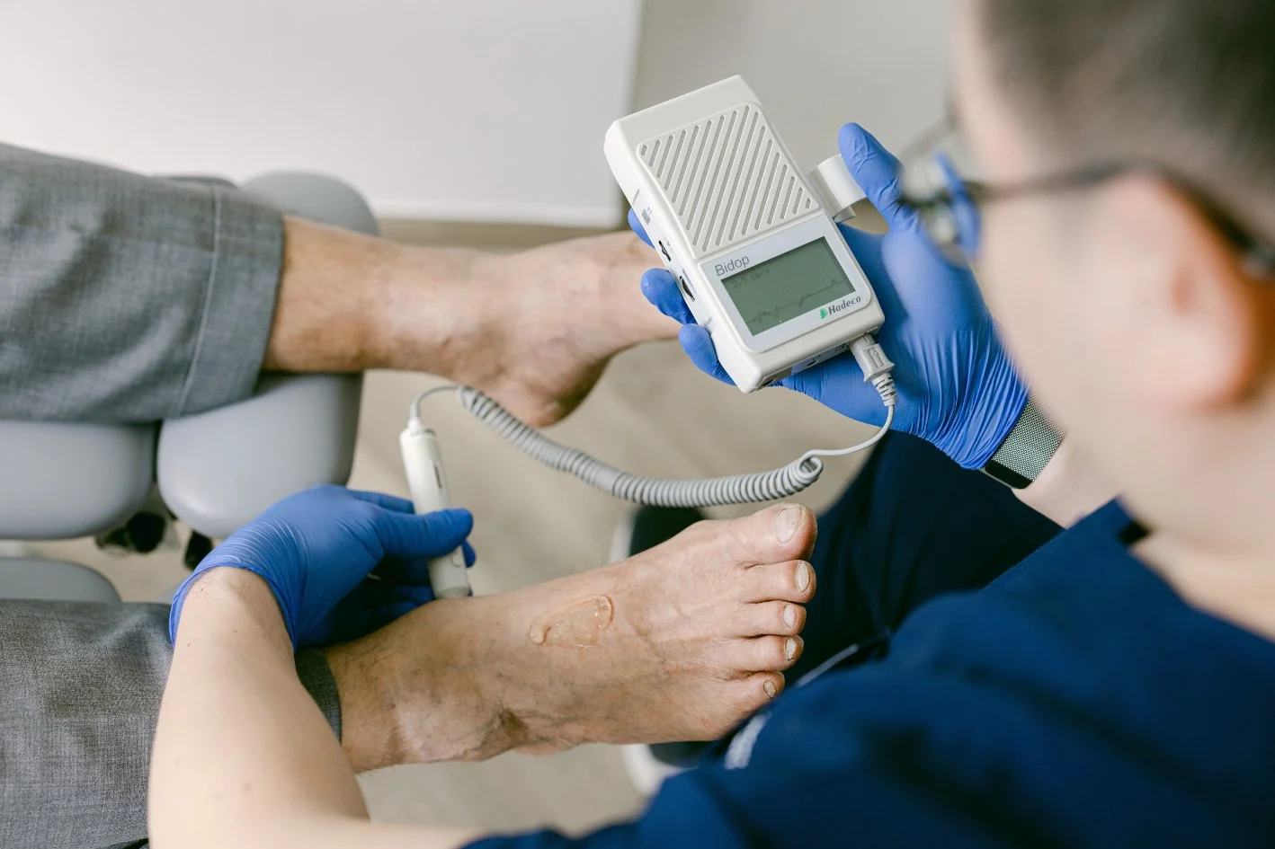 Podiatrist performing doppler ultrasound to check circulation to the feet.