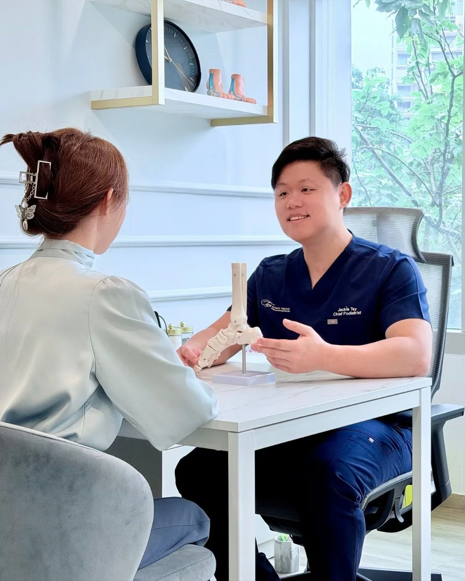 Podiatrist Jackie Tey consulting foot pain patient at Straits Podiatry Singapore