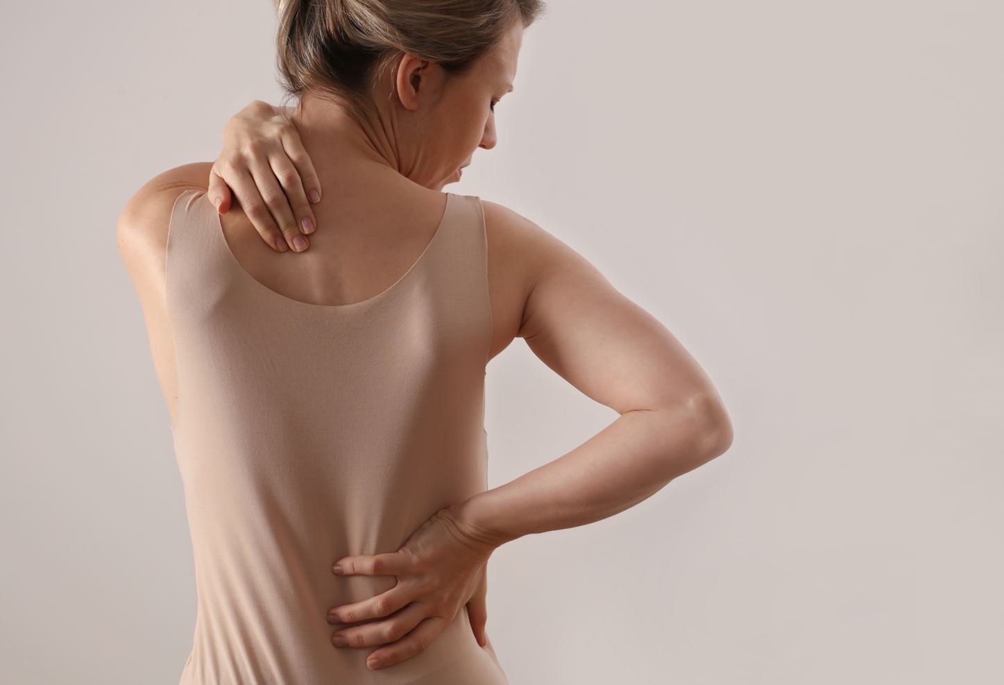 Woman suffering from malalignment syndrome related back pain