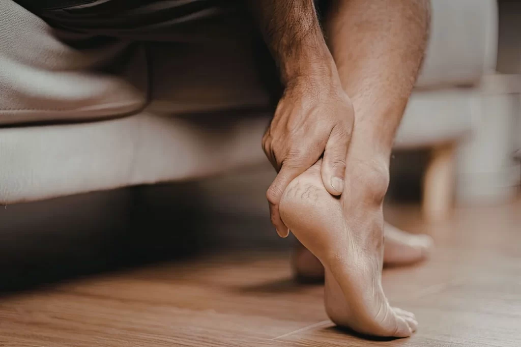 Person suffering from foot pain after rest