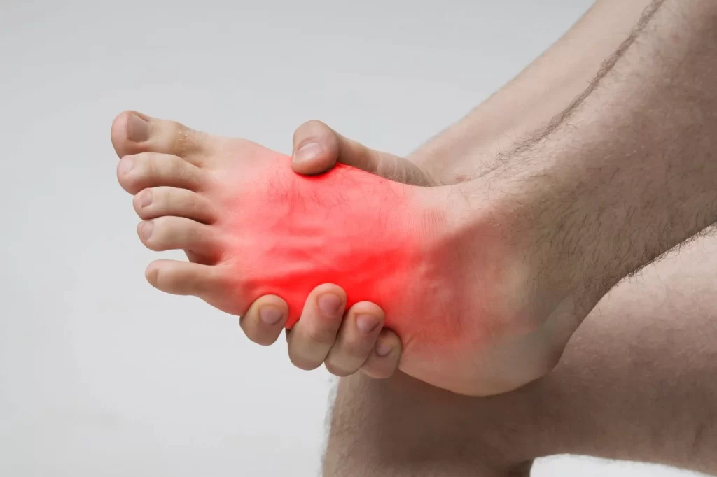 Person suffering from extensor tendonitis, causing pain on the top of the foot