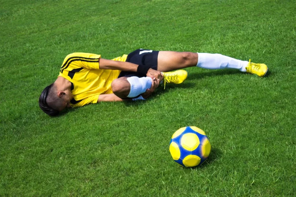 footballer suffering ankle sprain on field