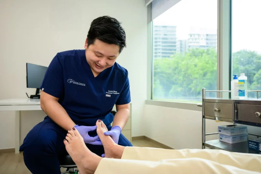 podiatrist in singapore assessing a bunion to differentiate from gout or sesamoiditis