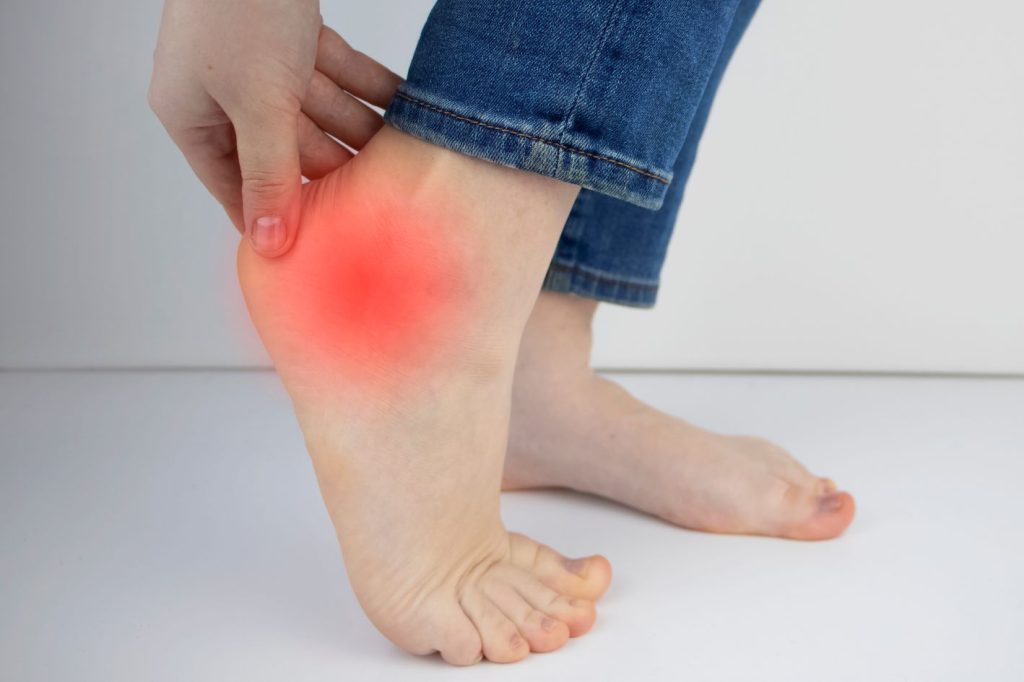Person with outer ankle pain from peroneal tendonitis